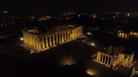 Aerial night video of iconic ancient Acropolis hill and the Parthenon at night, Athens historic center