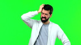 Man having doubts and with confuse face expression on green screen chroma key