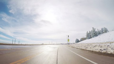 Denver, Colorado, USA-March 27, 2018-POV-Driving on suburban road after the Sping snow storm.
