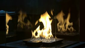 4K footage of decorative artificial fireplace with white stones in room interior