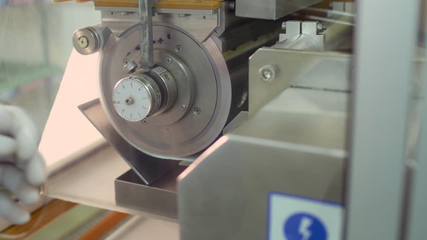 Worker in rubber glove adjust valve inside the machine