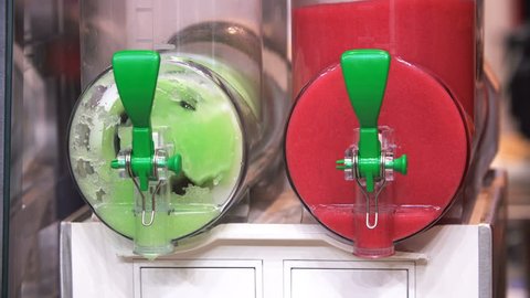 4K footage of colourful, cool, refreshing ice king slushy refreshment machine close up view