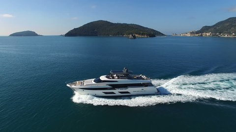 Aerial view of a yacht navigating off the coast of Portovenere, a small village in Northern Italy.