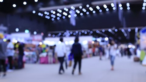the International export import trade fair hall with many creative customers, business buyers, modern visitors, press and exhibitor stands from around the world, Blurred Background Time lapse motion