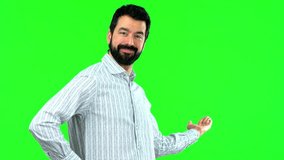 Man presenting and inviting to come on green screen chroma key