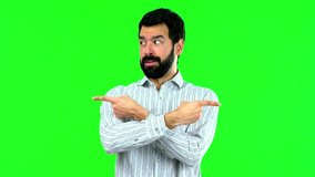 Man pointing to the laterals having doubts on green screen chroma key