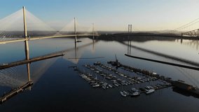 Aerial drone footage of Queensferry Crossing bridges over Firth of Forth bay, Scotland, United Kingdom.