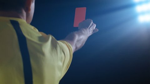Football soccer referee shows penalty red card
