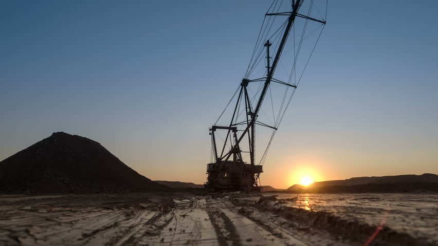 Dragline excavator at the sunset. Industrial concept.