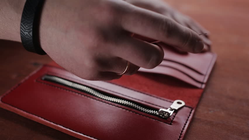 A man lays credit card pockets red wallet Royalty-Free Stock Footage #1010150357