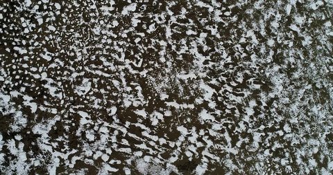Natural pattern created by snow partially covering a pasture on the Qinghai Tibetan Plateau. Aerial 4k footage.