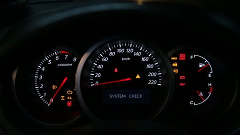 Car dashboard during start engine on the darkness