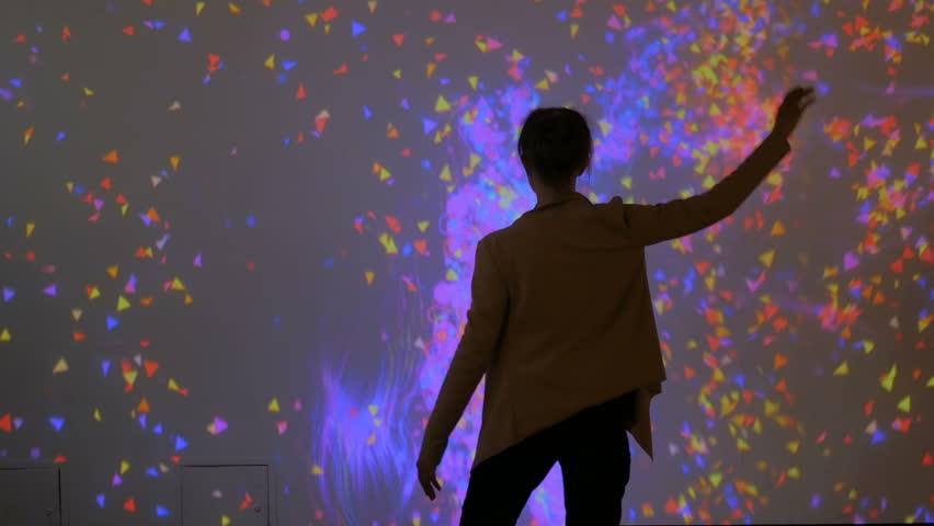 Large screen augmented reality experience - woman waving her arms in front of display. Science, future and technology concept Royalty-Free Stock Footage #1010157164