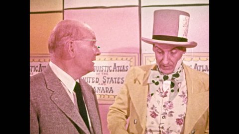 1950s: Man in top hat speaks to man in suit. Man in suit speaks to young girl and mad hatter.