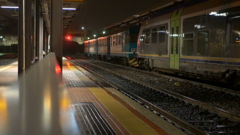 Train station in strong night rain, Trenitalia locomotives on the tracks, San Paolo Station, Biella, Italy , in April 11, 2018 
