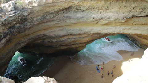 Algarve coast, Portugal. Aerial view of most impressive sea caves in Europe. Benagil Cave with boat trips leading to visit the caves from Praia de Benagil. Algar de Benagil is only accessible by sea.