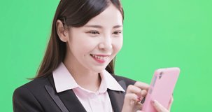businesswoman use phone on the green background