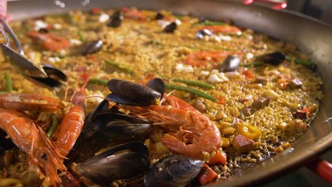 Ready Spanish paella. Separation of seafood from vegetables and rice.