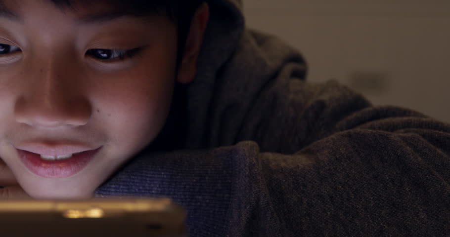 Close up of cute asian boy using tablet computer ,Young teenage boy playing games on digital tablet with smile face . Royalty-Free Stock Footage #1010177075