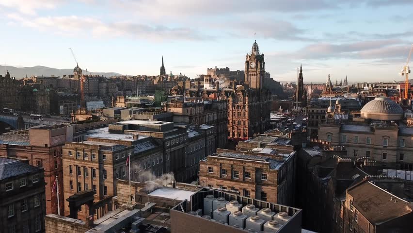 4K aerial drone video of a clock tower, castle, and ancient buildings in Edinburgh, Scotland during the morning Royalty-Free Stock Footage #1010178302