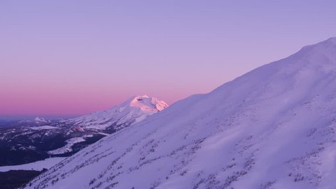South Sister and Mt. Bachelor, Oregon circa-2018.  Morning aerial view of South Sister mountain revealed from Mt. Bachelor, Oregon. Shot from helicopter with Cineflex gimbal and RED Epic-W camera.