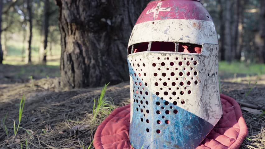 Old medieval helmet is lying on the grass