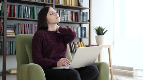 Tired Young Woman Working on Laptop in Office