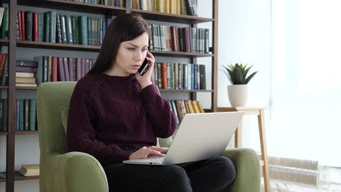 Casual Sitting Woman Attending Phone Call at Work, Talking on Phone