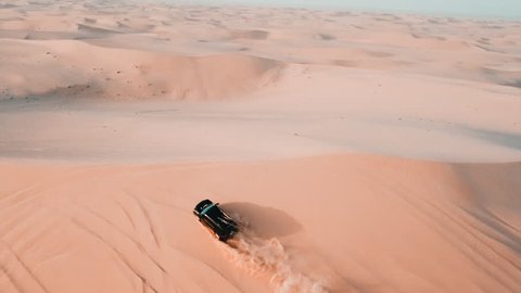 Extreme ride, sand mountain safari bird eye view, drone flying over the Dubai dunes, UAE desert, car driving and drifting