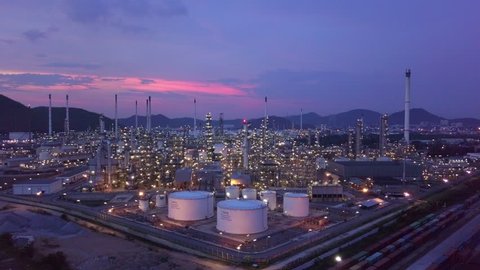 Oil and gas petrol fuel chemical tank with oil refinery petrochemical plant background at twilight, Business power and energy industry factory construction for people in the city, 4K