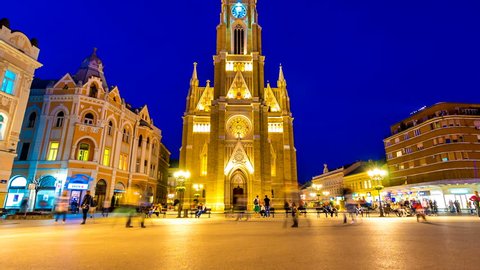 NOVI SAD, SERBIA - MAY 22: Time-lapse view on the Cathedral of the city at night as People pass by on May 22, 2017 in Novi Sad, Serbia.
