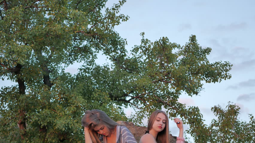 Two young girls posing on camera