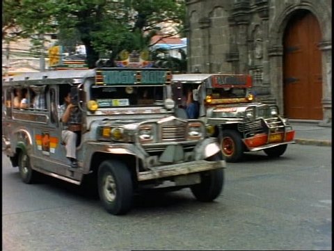THE PHILIPPINES, 1998, Manila, Jeepneys passing, Manila's inexpensive bus service