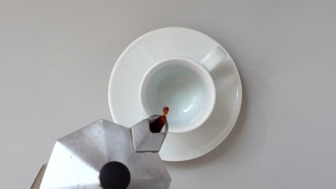 Pouring Coffee In a Cup. Gray table. Top view