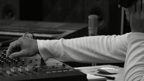 Male sound producer listening headphone adjusting and balancing sound of music from digital mixer volume in recording studio,HD slow motion monochrome.
Music producer working in recording studio. - Powered by Shutterstock - Get 15% off with code: PIKWIZARD15