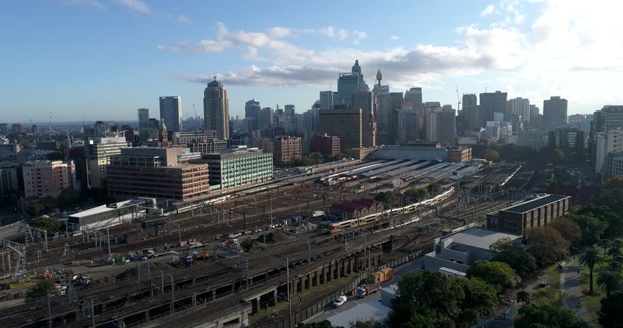 Sydney Central train station surrounded by high-rise office towers with many railway tracks coming to platforms for commuters and passangers.
