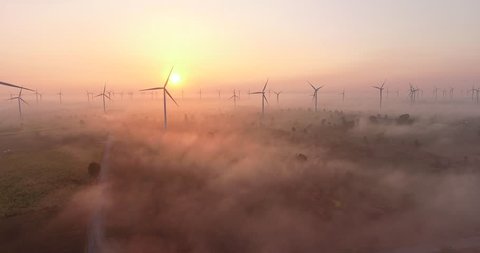 Aerial view of Wind turbines Energy Production- 4k aerial shot on sunset. 4k drone footage turbines at sunrise with clouds
