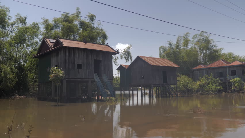 Flood waters under stilt houses in a village.
