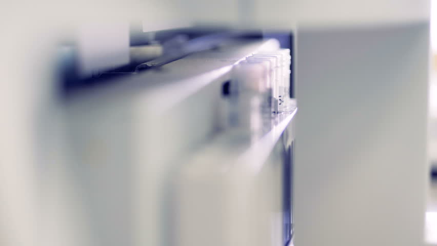 Plastic tubes with blood are being tested in a special machine. 4K.