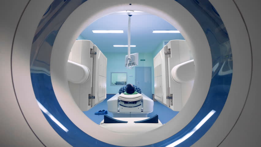 Tomograph in action. Patient on magnetic resonance medical examination. A medical device scans a man. Royalty-Free Stock Footage #1010228492