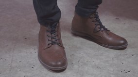 Feet nervous men in brown shoes
