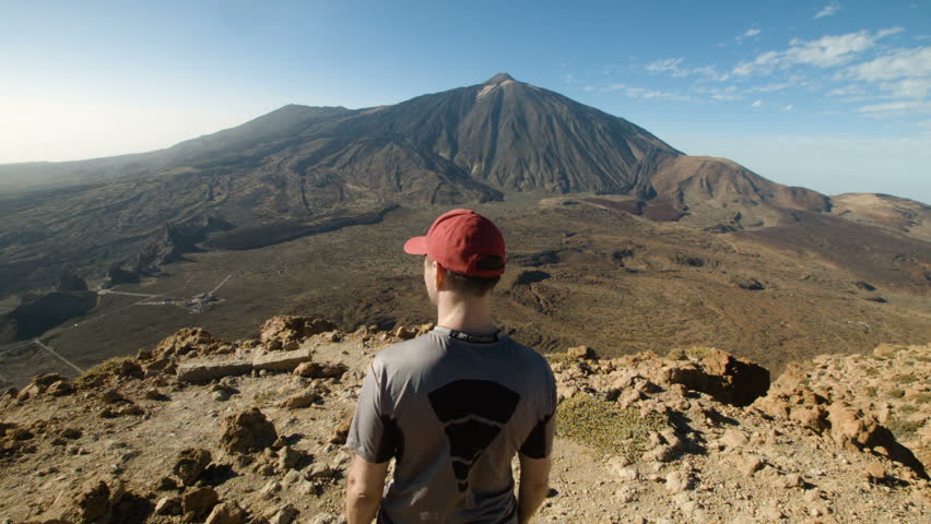 Mountain Peak. Man Standing and Raising His Hands