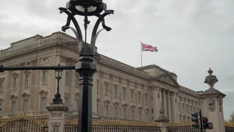 Union Jack flag flying over Buckingham Palace.

Front of Buckingham Palace in London. Includes camera move.