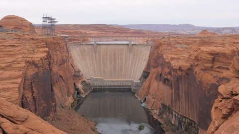 Panorama bottom up a view of Glen Canyon dam on the river Colorado in Arizona, USA. This huge dam produces environmental clean hydroelectricity power from lake Powell, 4k, 3840x2160