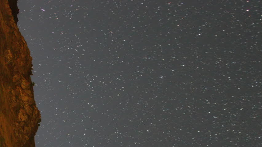 Vertical video. Traces from stars in the form of evanescent traces. Milky Way over the mountains