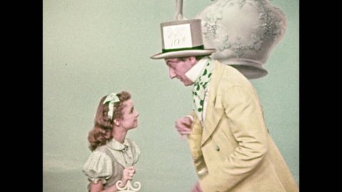 1950s: Mad Hatter talks animatedly, smiles, young girl listens. Mad Hatter shakes hand of man with trumpet, introduces him to girl, talks sternly.