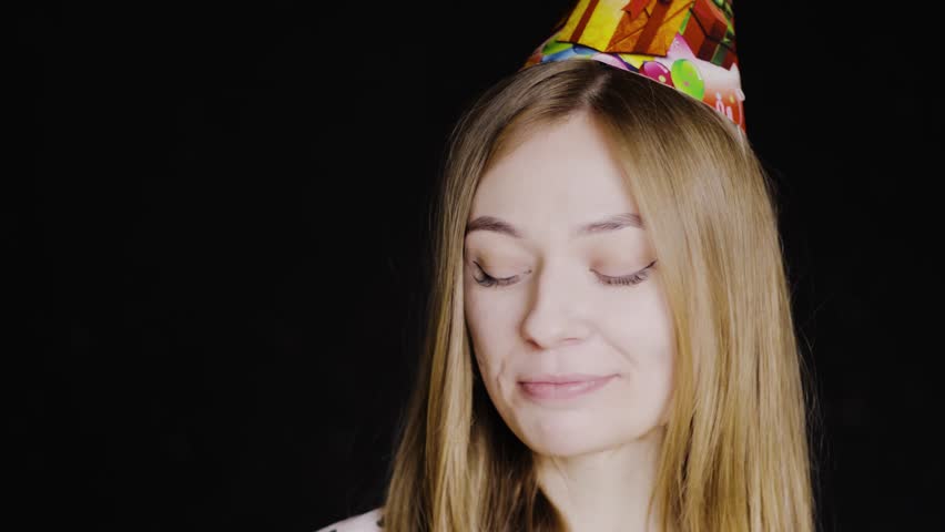 Birthday. The girl received a birthday present. Gift in the box. She is wearing a hat. She was happy. 4k