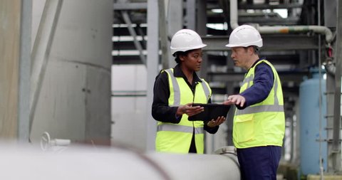 Industrial workers using a digital tablet on site