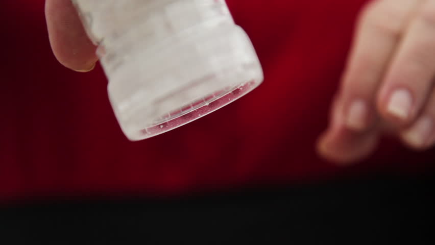 A close up shot of a person grinding pepper and salt.