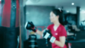 Shot slow motion of Female Boxer training in gym